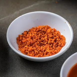 a bowl of red rice and a bowl of soup