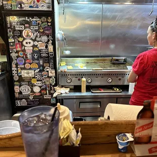 At the counter watching them cook