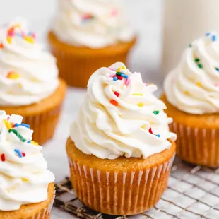 cupcakes with white frosting and sprinkles