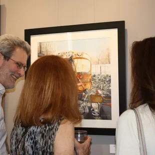 Visitors discussing artwork