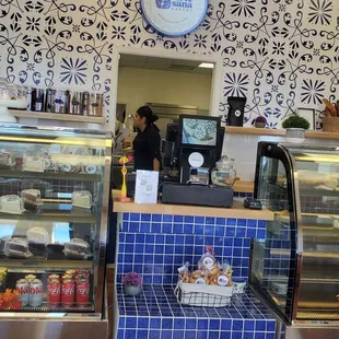 a counter with a display of pastries