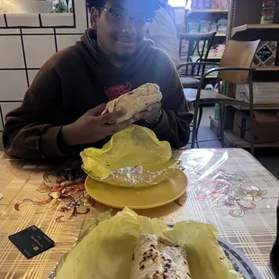 a man eating a burrito