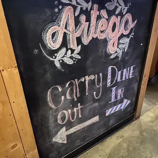 a chalkboard sign for a restaurant
