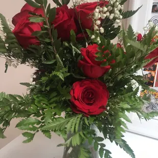 Different sized roses some old and some fresh in a lazy put together arrangement