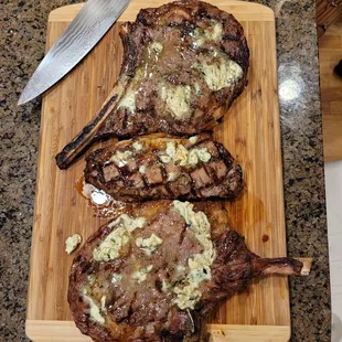 two steaks on a cutting board
