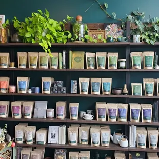 a shelf of teas and plants