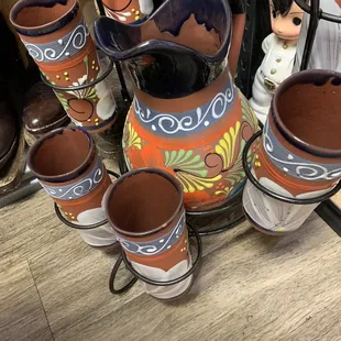Set of a pitcher with cups painted with beautiful colors throughout