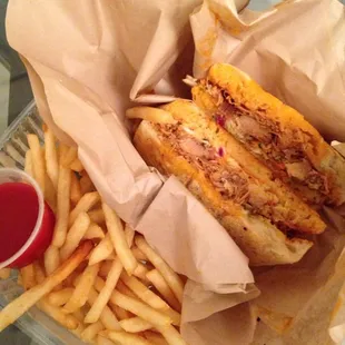 Pulled chicken sandwich with papas fritas. $8.50+$2.00. Delicious!