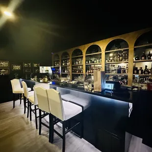 a bar with white chairs