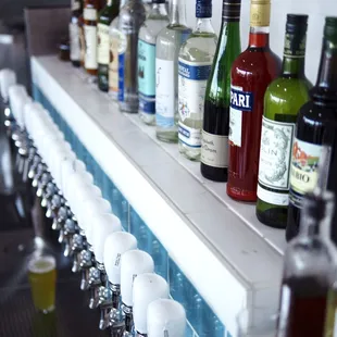 a row of liquor bottles on a bar