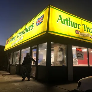 The lit up front entrance to the newly REOPENED Arthur Treachers!