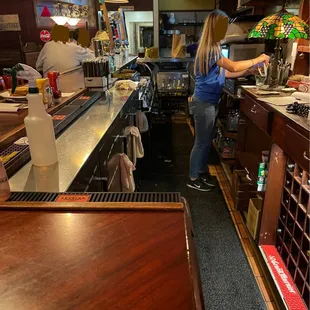 a woman standing at the bar