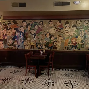 a mural of cartoon characters on the wall of a restaurant