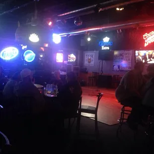 people sitting at tables in a dimly lit room