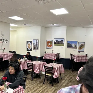 people sitting at tables in a restaurant