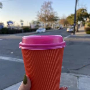 a hand holding a cup of coffee