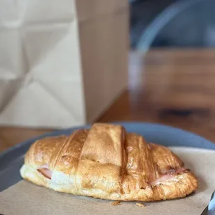 Ham and Brie croissant, warmed up to enjoy and a goodie bag of pastries and drinks to go