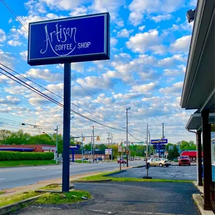 a blue sign on the corner of a street