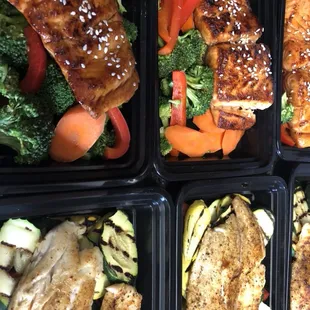 Teriyaki salmon bowls and seared talapia with grilled veggies being prepared for delivery.