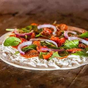 a pizza topped with vegetables