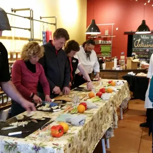 Students learning how to use a knife at Artisano's