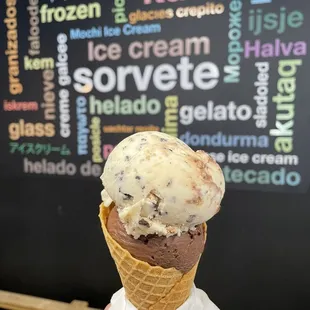 a hand holding a cone of ice cream