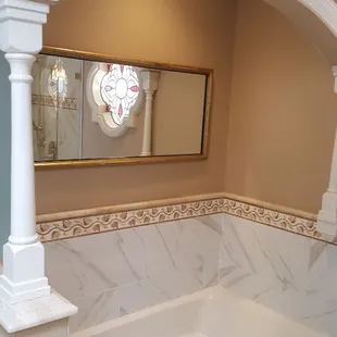 Porcelain tile calcatta marble look with travertine listel and pencil liner