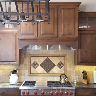 a kitchen with wood cabinets and granite countertops