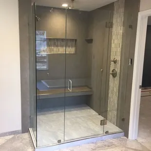 18x36 tight fit wall tile, stone multi surface mosaic, liner drain W/ 12x24 tight fit porcelain, schluter rondec trim, and framless glass