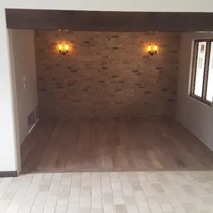 Limstone floor, india walnut and brick venerr wall for entertainment room