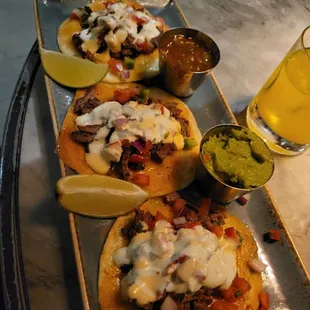 a plate of tacos and a glass of beer