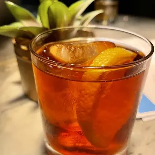 a glass of tea with orange slices