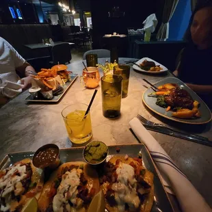 a table with plates of food and drinks