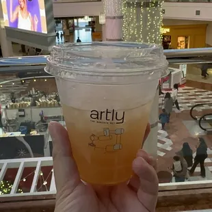 a hand holding a cup of coffee