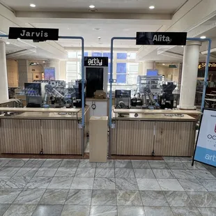 a coffee shop with a sign in the foreground