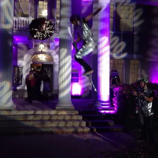 Pogo stick acrobats at the entrance to the party