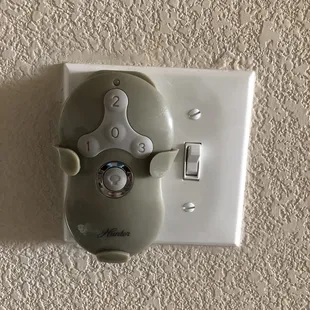 Wireless Fan remote mounted on wall.