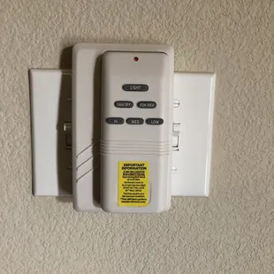 Wireless Fan remote mounted on wall.