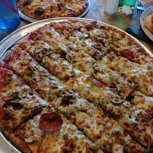 Around the World large pizza and Mini Spaghetti with meatball pizza in background