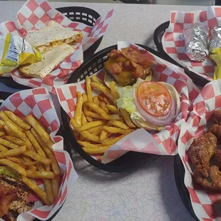 Variety of our foods. Bacon cheeseburger, chicken quesadilla, chicken sandwich, buffalo chicken wings