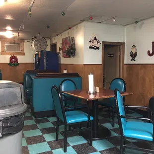 a dining room with blue chairs and a black and white checkered floor