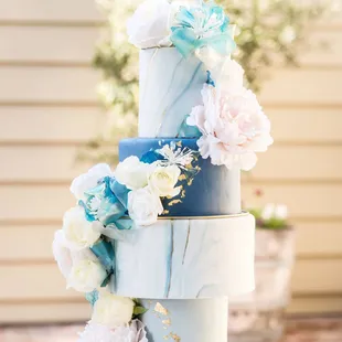 a three tiered cake decorated with flowers