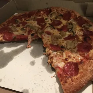 a half eaten pizza in a box