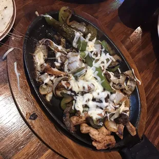 Chicken &amp; Steak Fajita Combo, started eating before snapping a picture. Came out sizzling and was so fulfilling