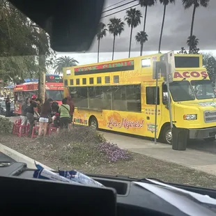 a yellow bus parked on the side of the road