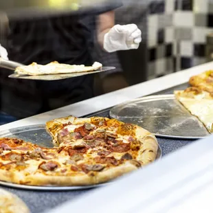 a person serving pizza