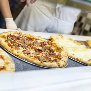 three pizzas on a counter
