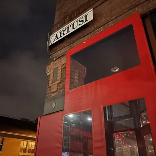 a red door and a street sign