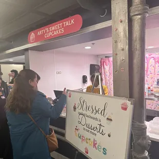 a woman writing on a sign