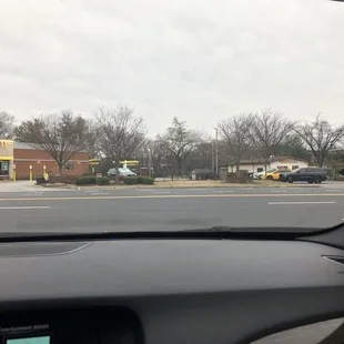a view of a parking lot from inside a car